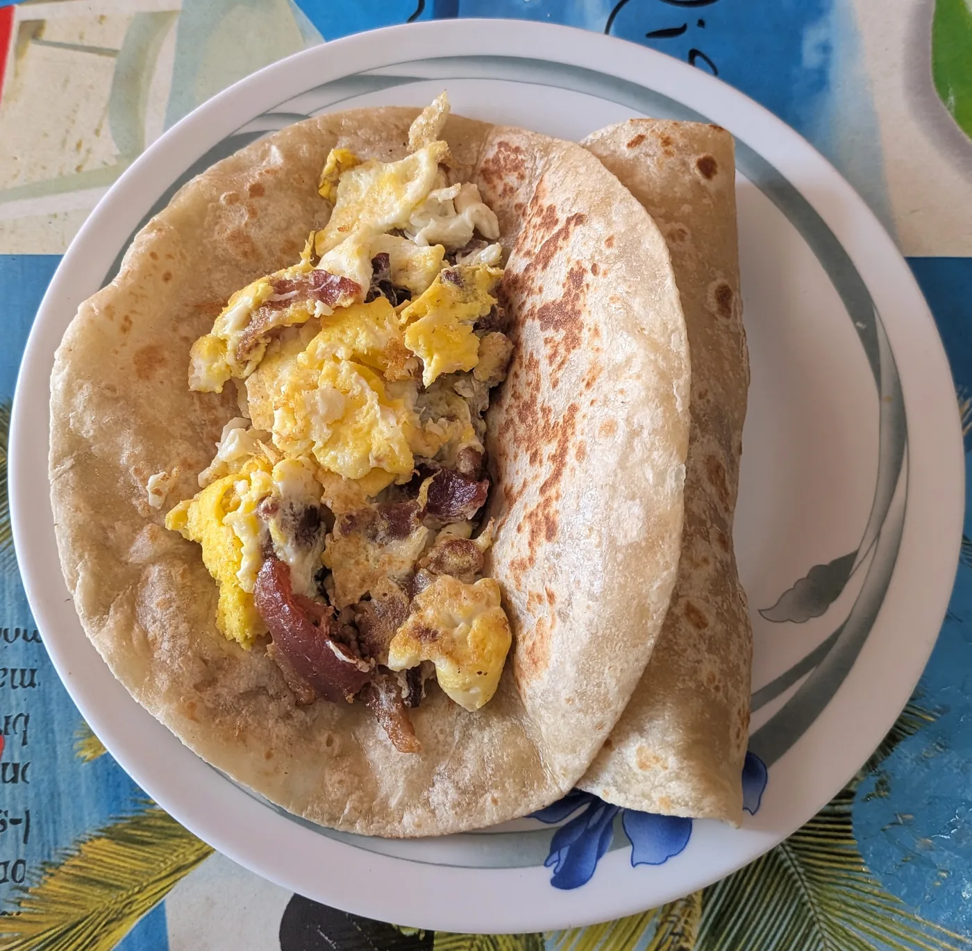 Breakfast tacos with egg and meat on a plate